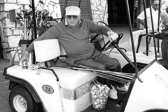 A man driving a golf cart