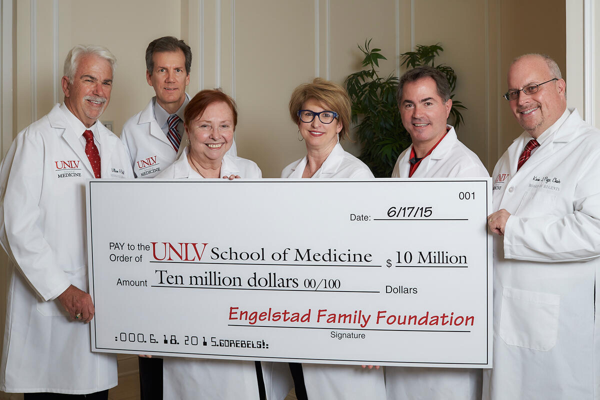 Bill Boldt, Mark Doubrava, Barbara Atkinson, Kris Engelstad McGarry, Len Jessup, and Kevin Page hold up giant check